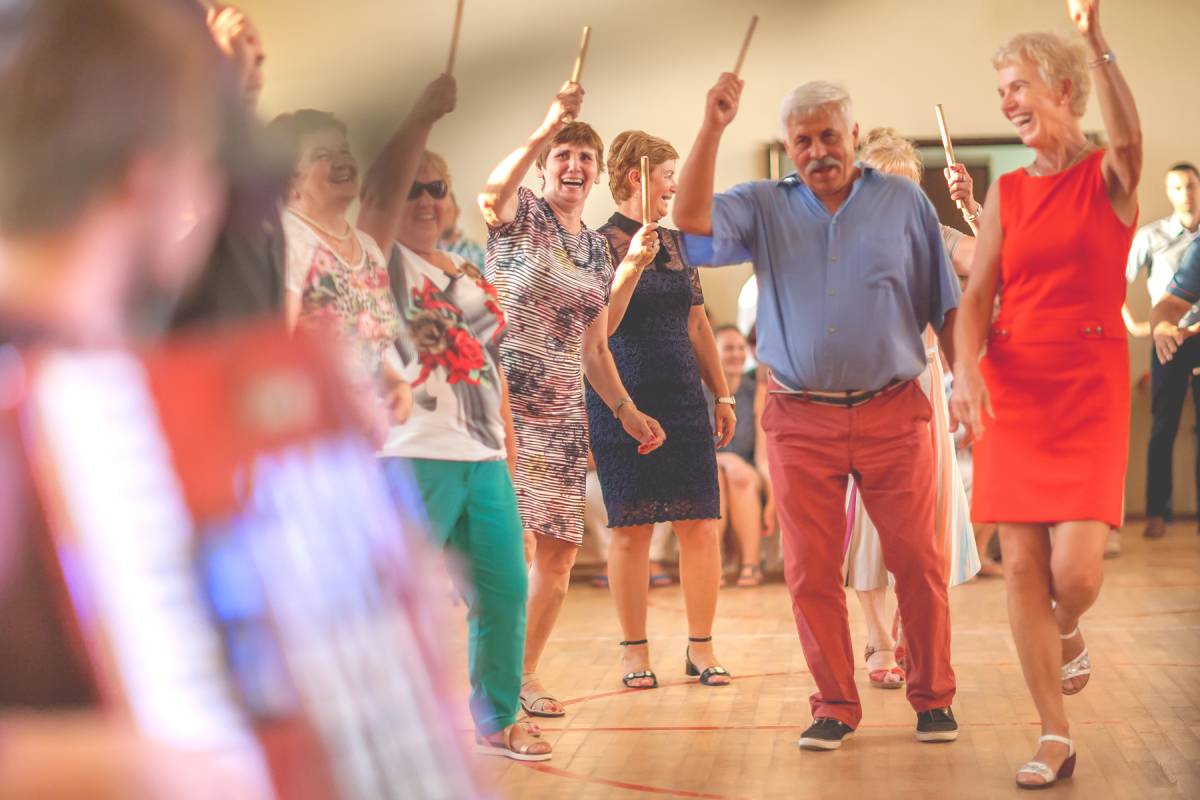 Zdjęcie ukazujące bawiących się i tańczących seniorów podczas potańcówki w Domu Kultury na osiedlu A w Tychach. Autor: Artur Pławski