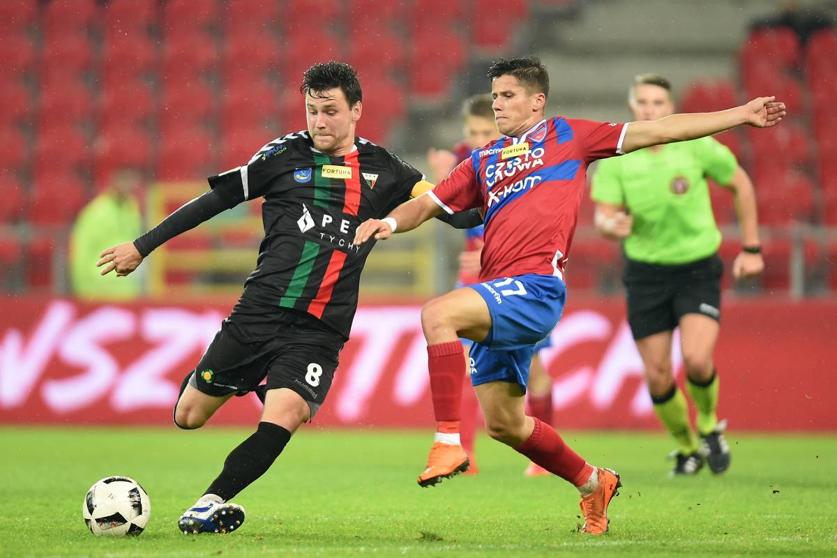Łukasz Grzeszczyk, kapitan piłkarskiej drużyny GKS Tychy oddaje strzał na bramkę.